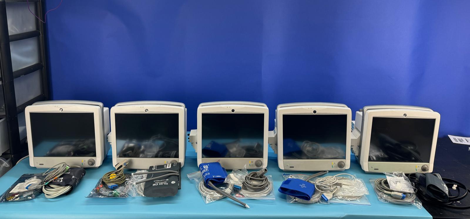 5 pieces of GE carescape B650 Monitors screens turned off, cables and attachments in front