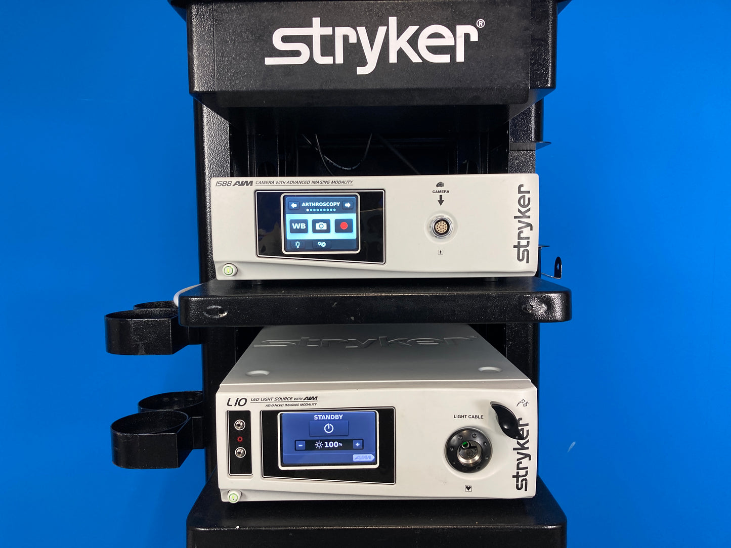 Stryker 1588 AIM camera control unit is an advanced medical imaging system designed to provide high quality and accurate visualization during surgical and medical procedures. The LED light source provides real-time endoscopic visibility and near-infrared fluorescence imaging. Enables surgeon to perform minimally invasive surgery using standard endoscopic visible light as well as visual assessment of vessels, blood flow, related tissue perfusion and biliary anatomy near-infrared imaging.